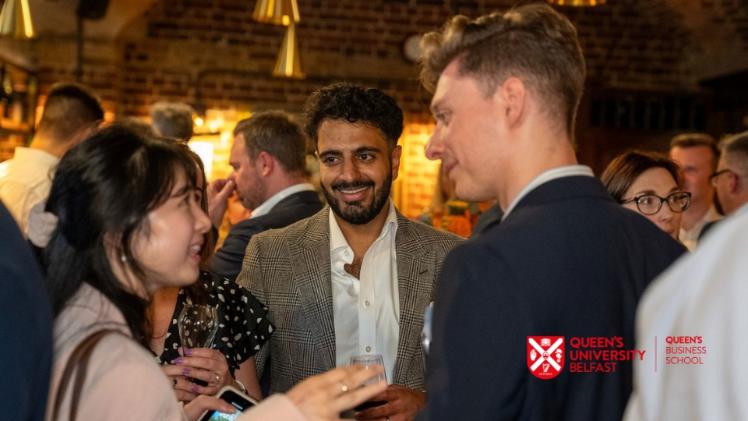A woman talking to two men